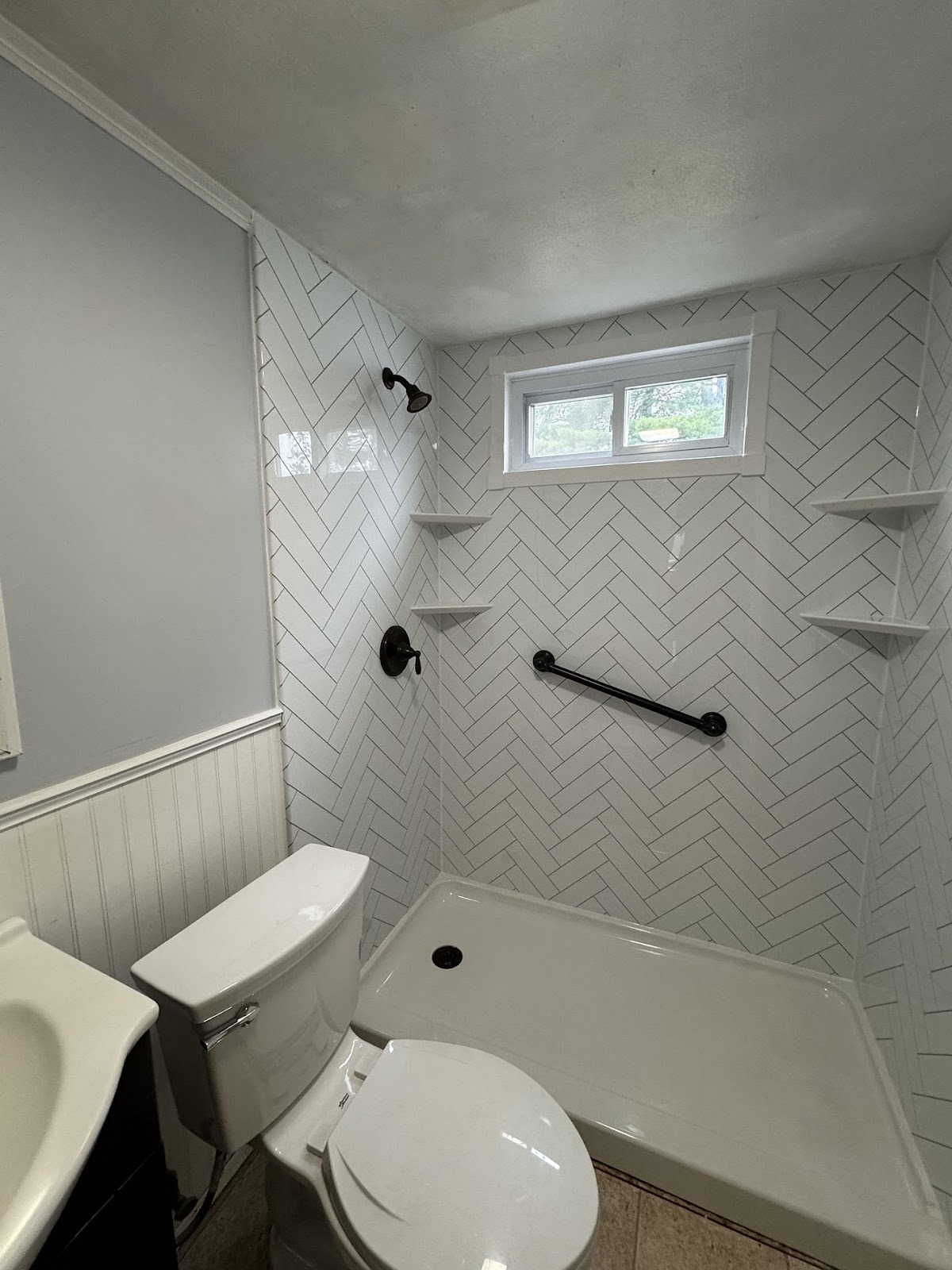 white walk in shower with grab bar